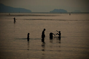 4 or 5 people in a peaceful tropical beach scene